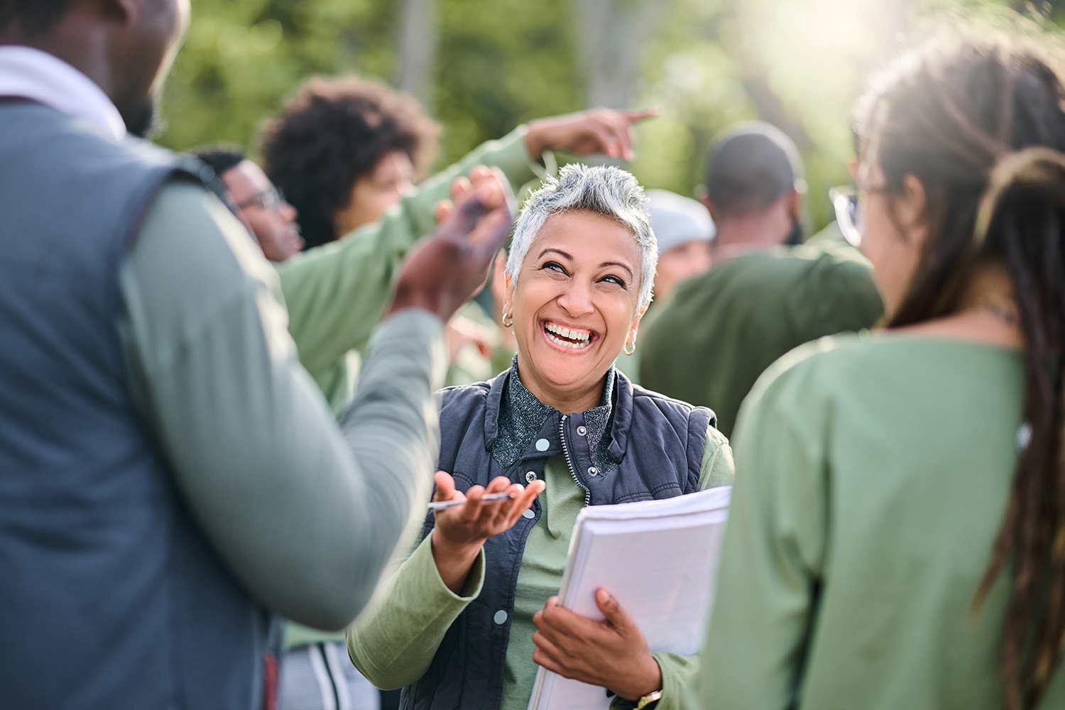 An event organizer laughing and talking to people outside